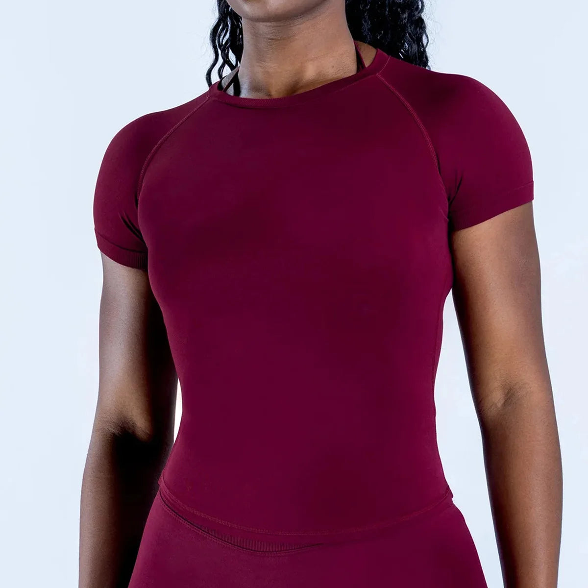 Haut de sport femme uni à manches courtes et col rond, en maille serrée, respirant, idéal pour le fitness et le yoga. Nouveau style.